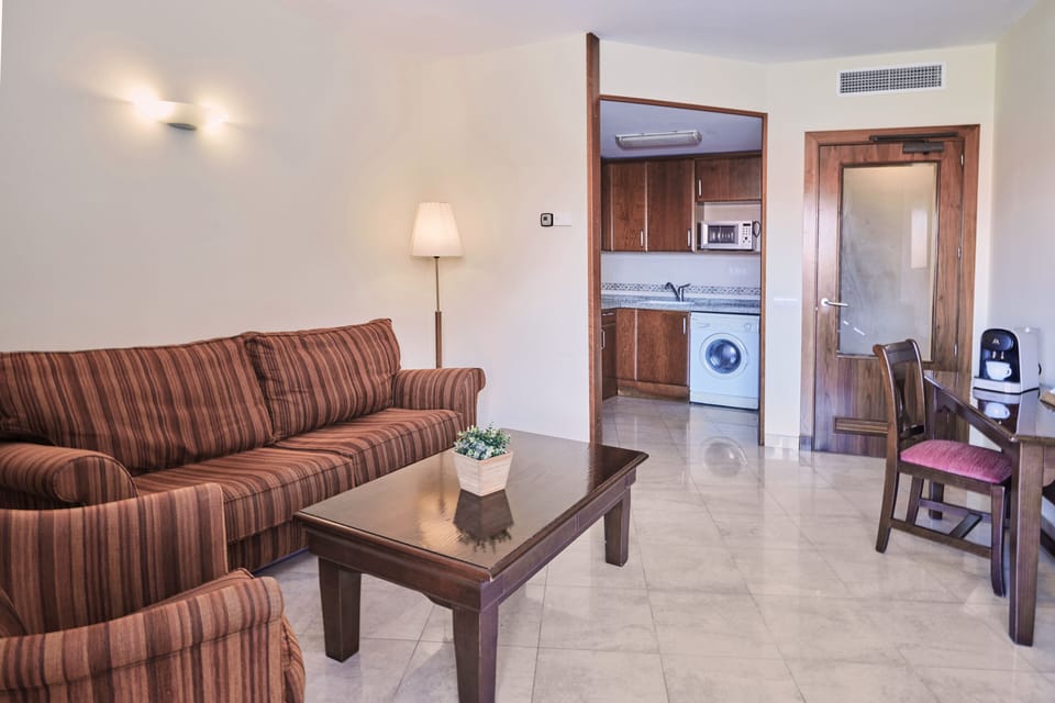 Family Apartment, Pool View | Living area | 26-inch flat-screen TV with satellite channels, TV, foosball