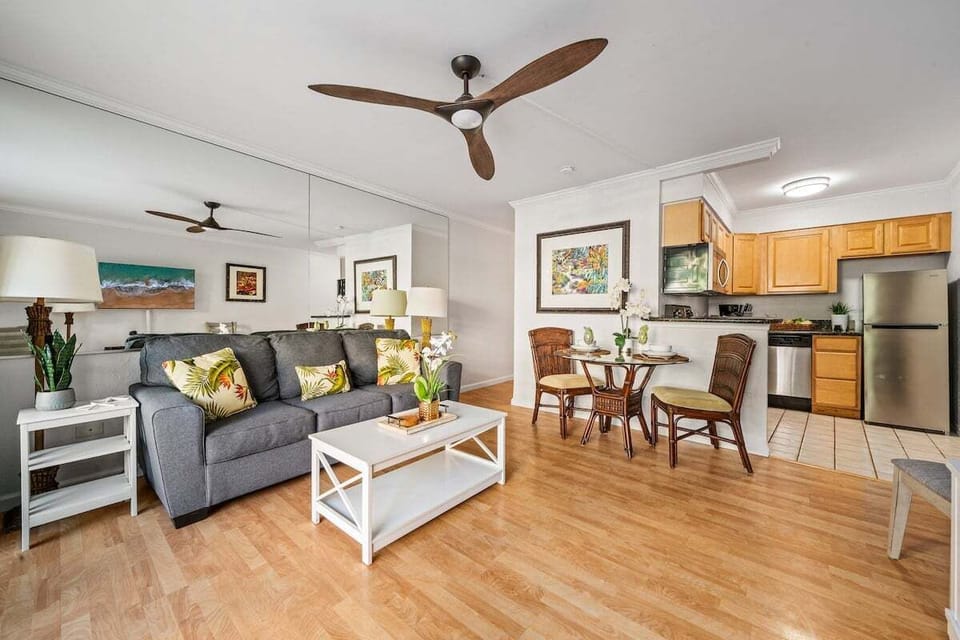 Open‑concept design with kitchen, stainless appliances, and warm wood cabinetry.