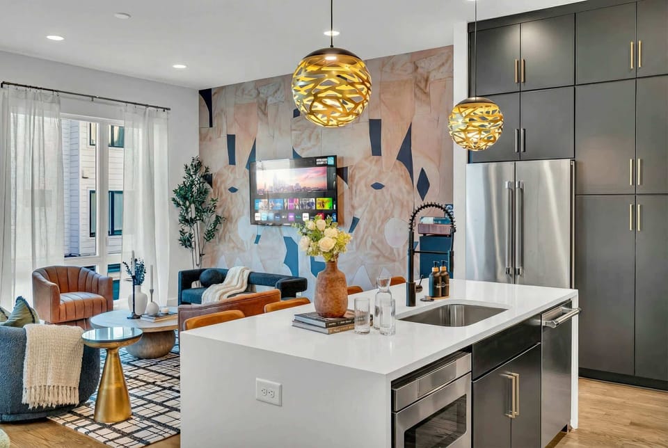 The kitchen opens directly to living space, so the person prepping snacks or mixing drinks stays woven into conversations instead of isolated at the counter