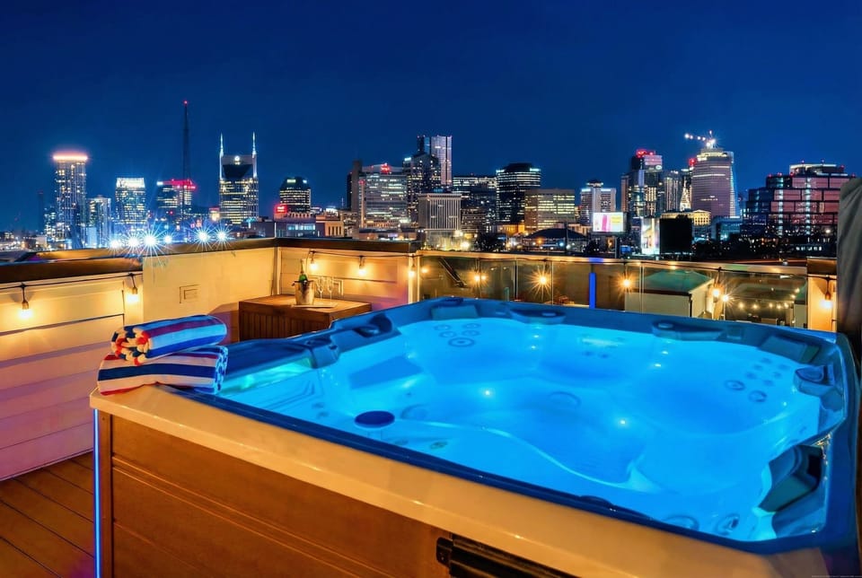 Twelve people fit in this rooftop sanctuary, steam rising into the cool night while the city sparkles all around you