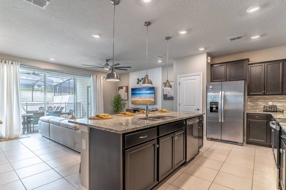 Open concept kitchen, dining and living area with direct access to the private pool!