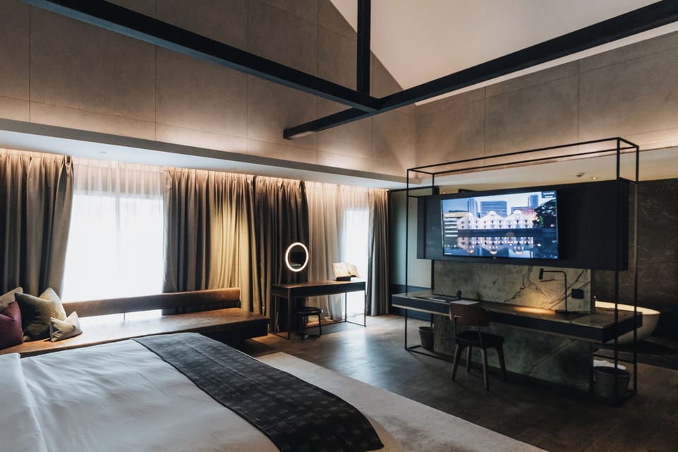 Suite, River View | Minibar, in-room safe, desk, blackout drapes