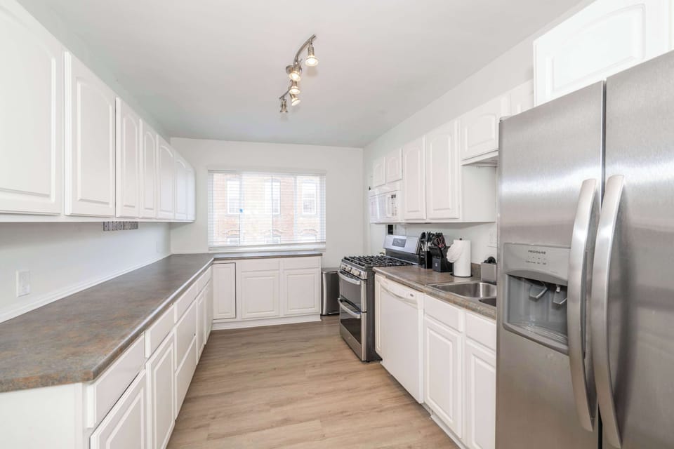 The airy kitchen offers ample space & all the comforts of home