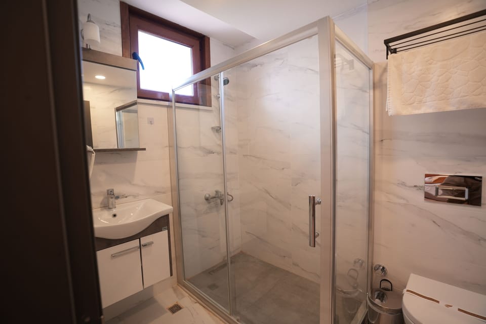 Shower, hair dryer, slippers, towels