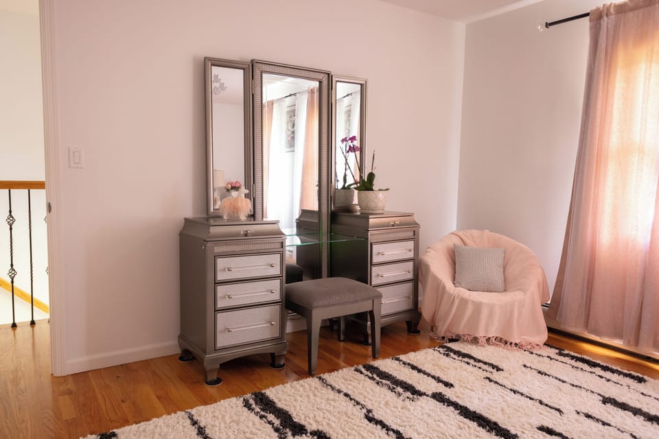 Bedroom 3 also has vanity with stool and a small sitting chair. 