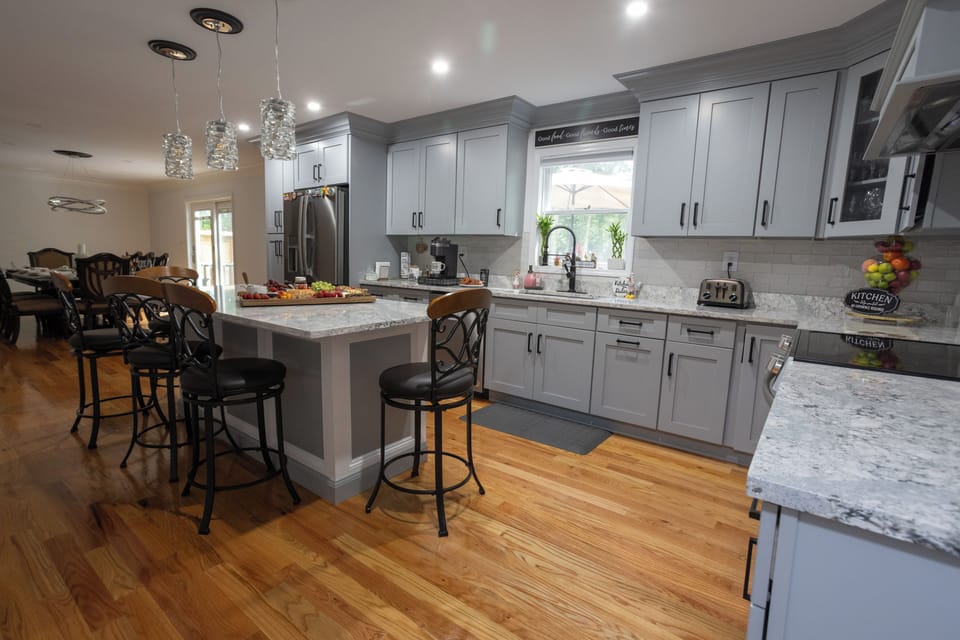 Kitchen with dining area in the background. Slider door goes out to backyard. 