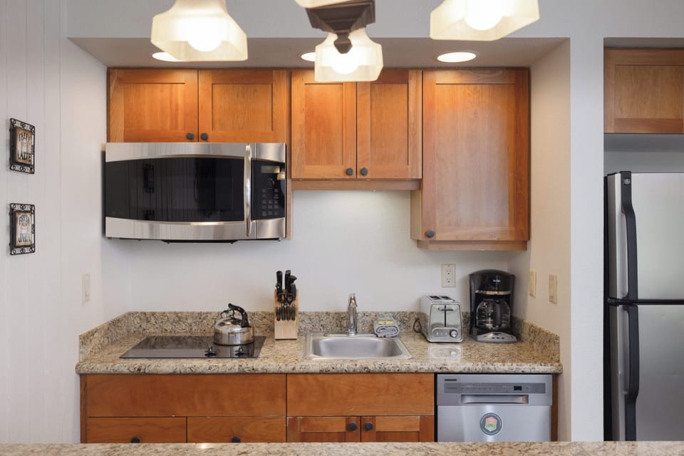 A compact yet functional kitchen with modern appliances and granite countertops