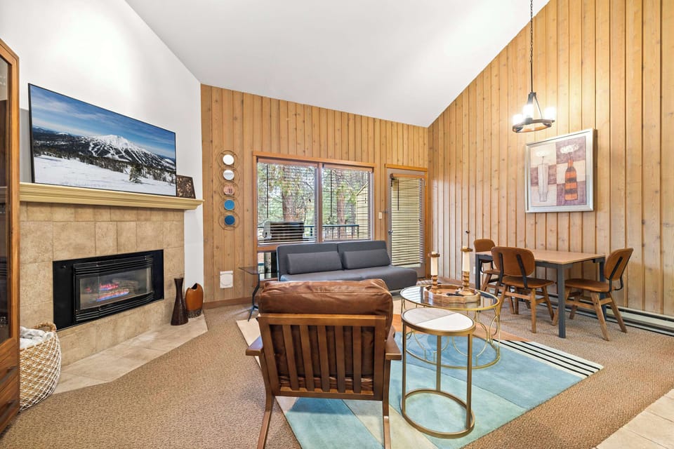 Spacious open living space with sofa sleeper and gas fireplace