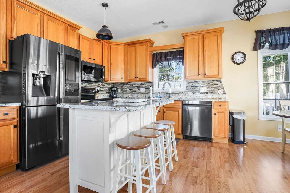 Spacious kitchen with modern appliances and breakfast bar seating