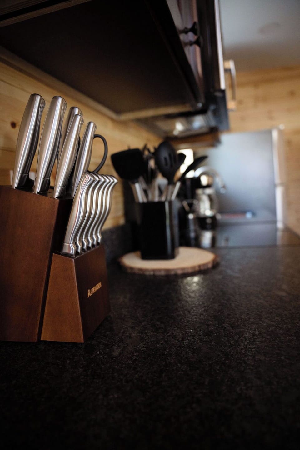 Knife block, cooking utensils, coffee pot, and other amenities provided for your convenience.