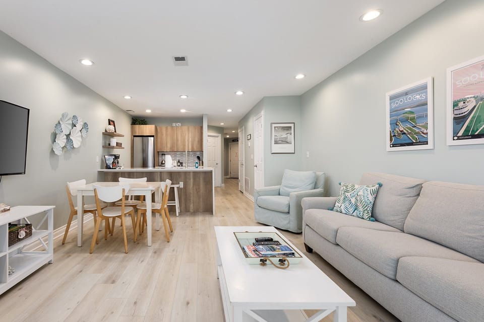 Open-concept layout connecting the living room, dining area & kitchen.