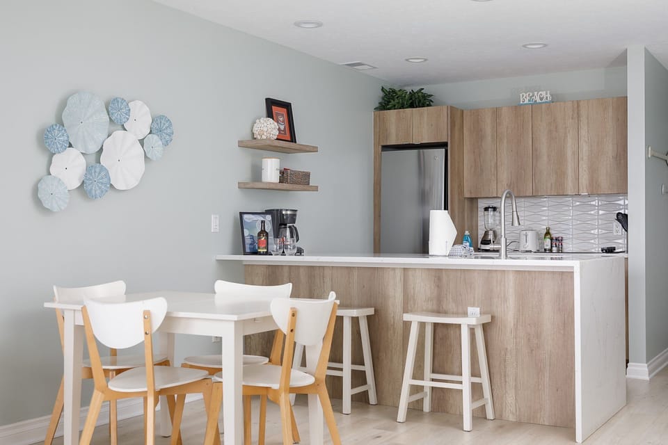Modern kitchen w/ breakfast bar seating & a cozy dining nook for easy meals.