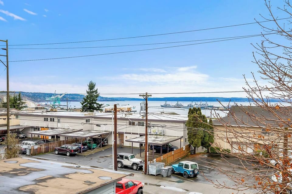 A stunning view of the waterfront and surrounding area, complete with ships and natural beauty.