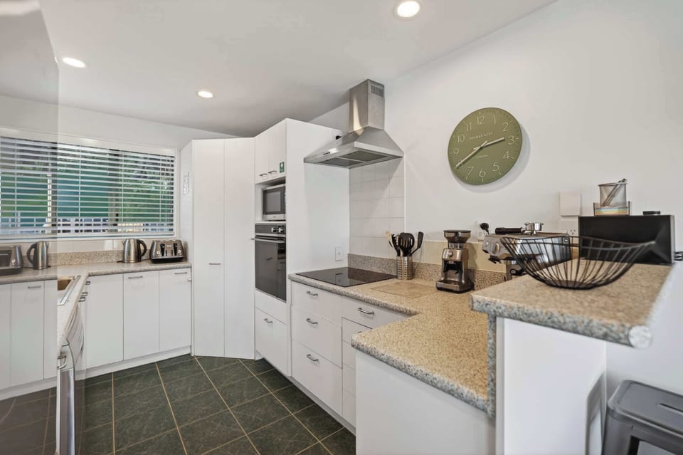 Kitchen with amenities including espresso maker, coffee grinder and coffee beans from local coffee roaster Black Lab Coffee
