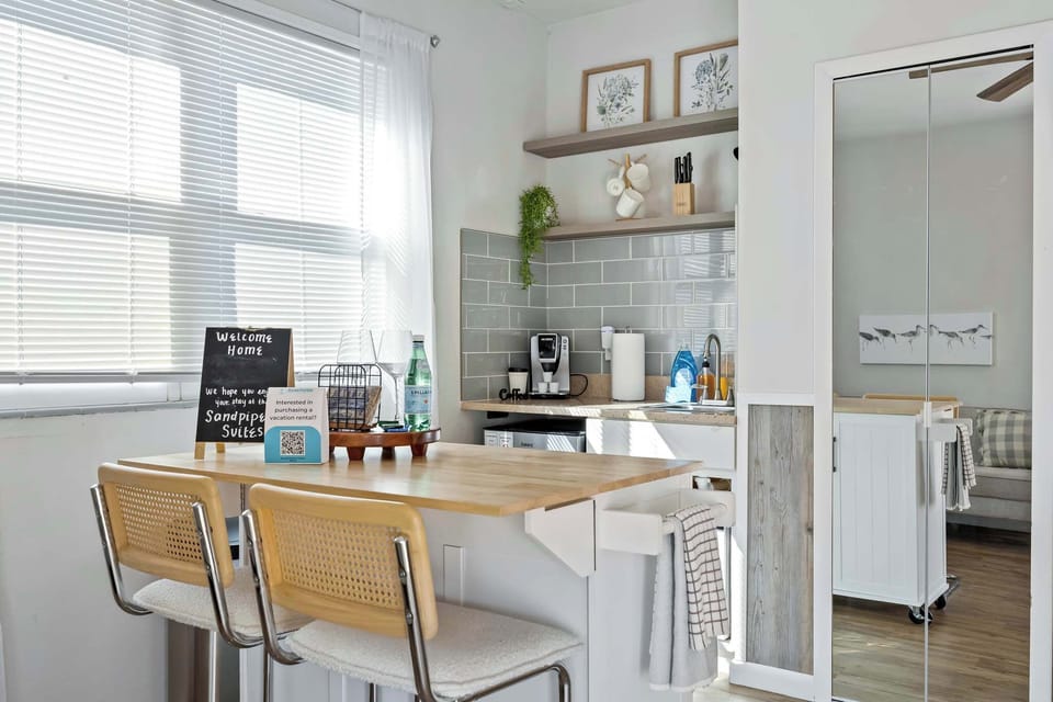 Bright kitchen area with a breakfast bar and modern gray tile backsplash