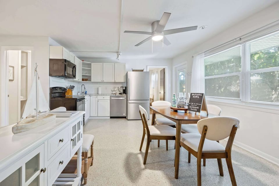 Bright kitchen and dining area with modern appliances and natural light.
