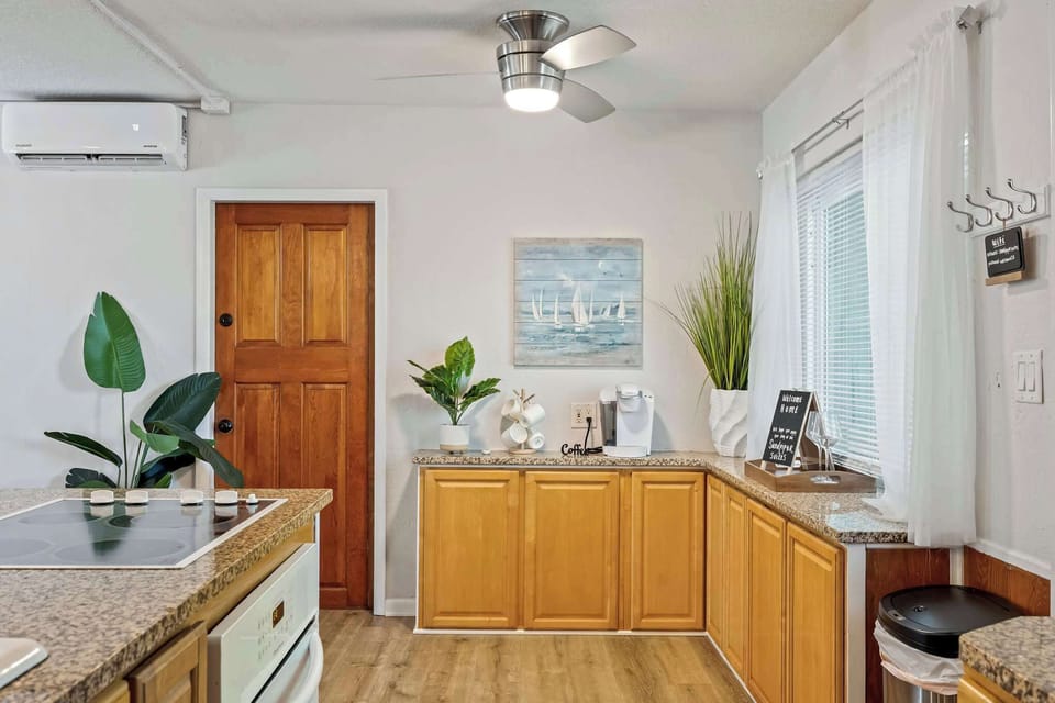 Modern kitchen with granite countertops and natural wood cabinets