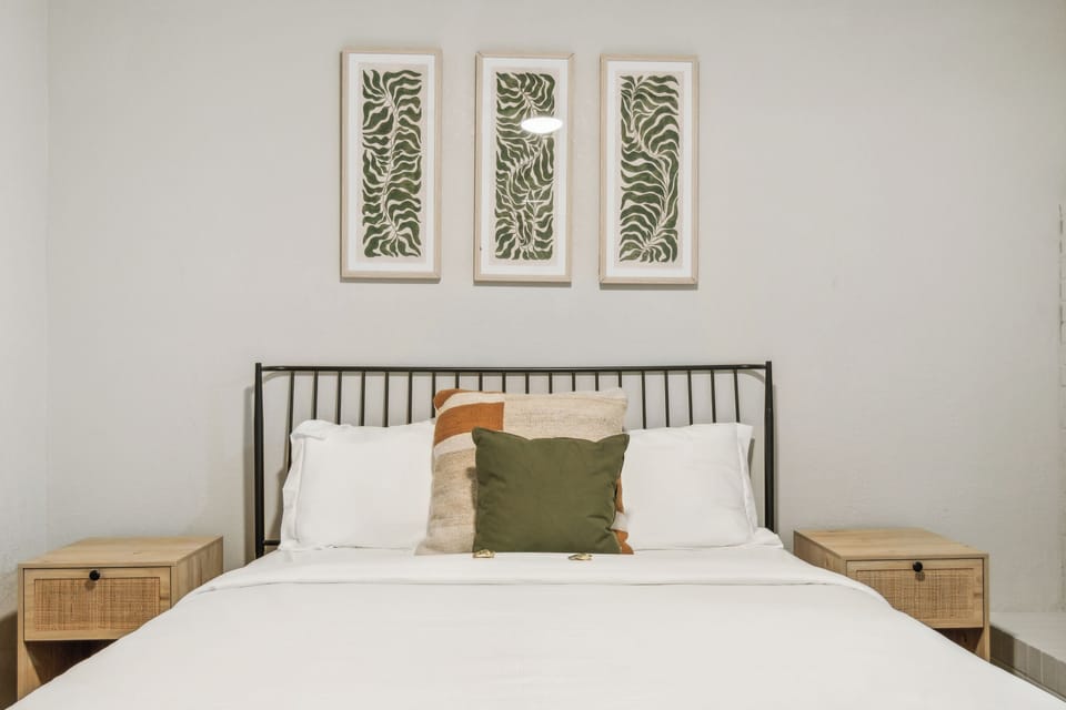 Front view of the COMFY queen bed in this large bedroom.