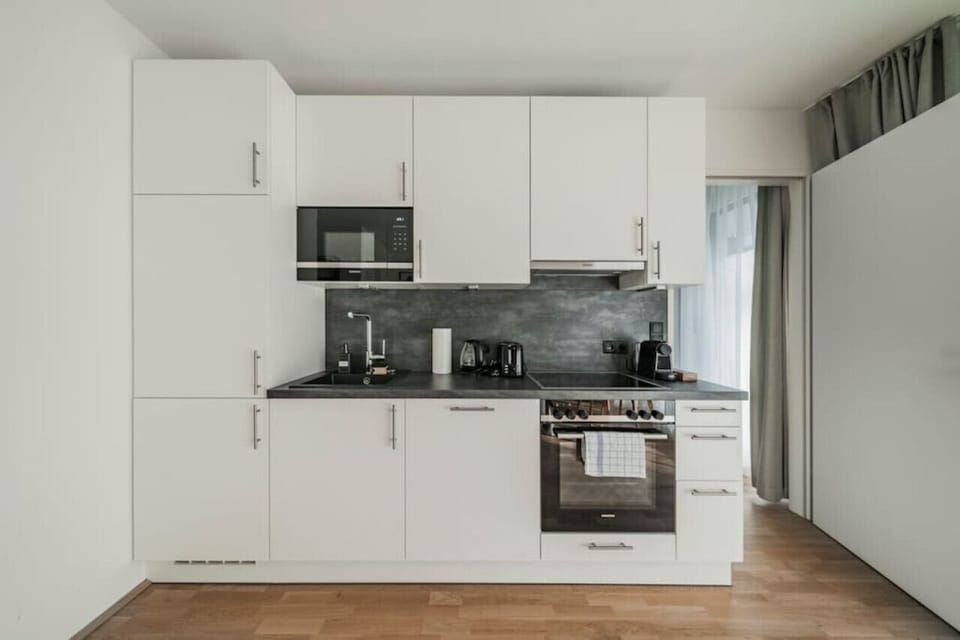 Step into the kitchen, where Arbio Designers have created a culinary haven, blending functionality and style seamlessly.