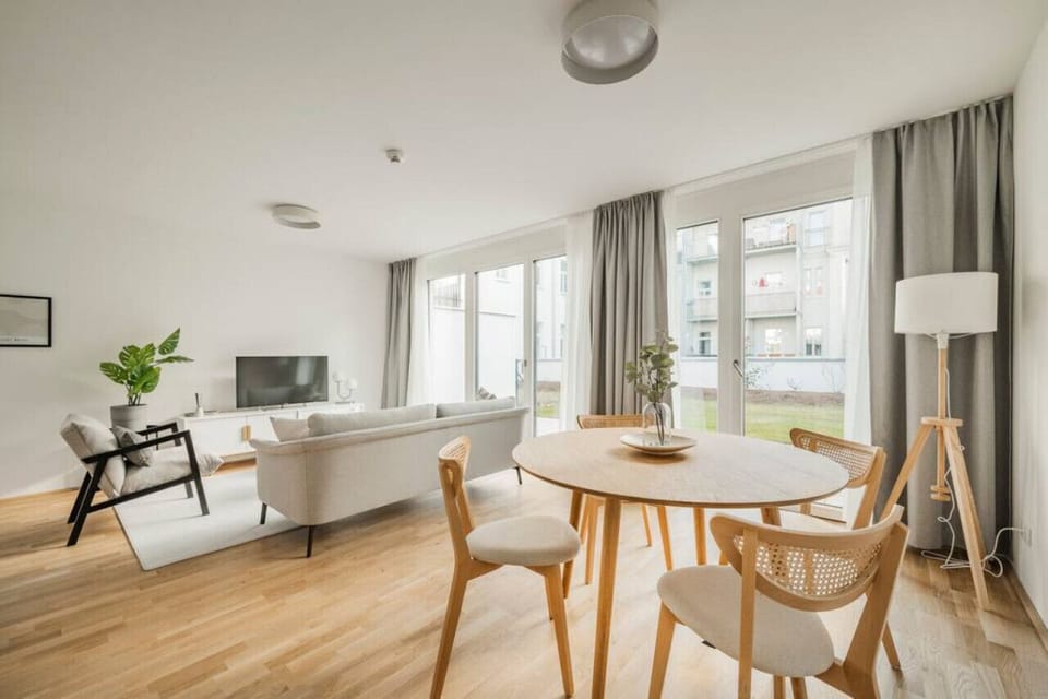 Step into the living room, where Arbio Designers` expertise shines through, creating a warm and inviting atmosphere, perfect for socializing or watching TV.