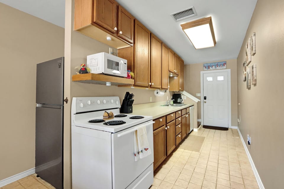 The kitchen is fully stocked with all appliances needed for a home cooked meal