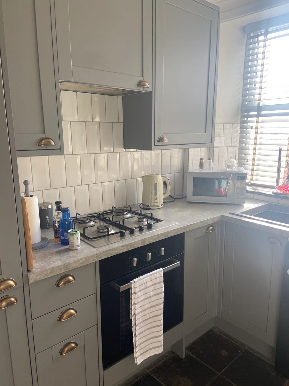 Modern kitchen, has air fryer, microwave and full cooker, toaster, kettle.