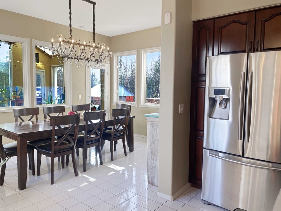 Family dining is surrounded by windows and full of natural light.
