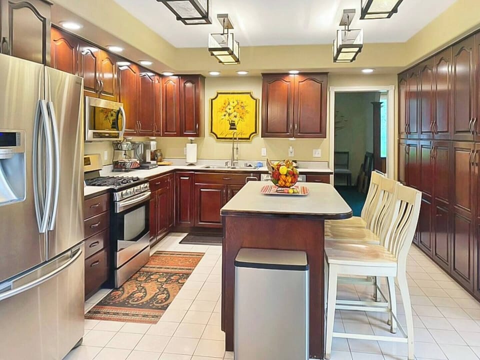 Spacious kitchen with countertop dining, extensive cabinets, and equipment's.