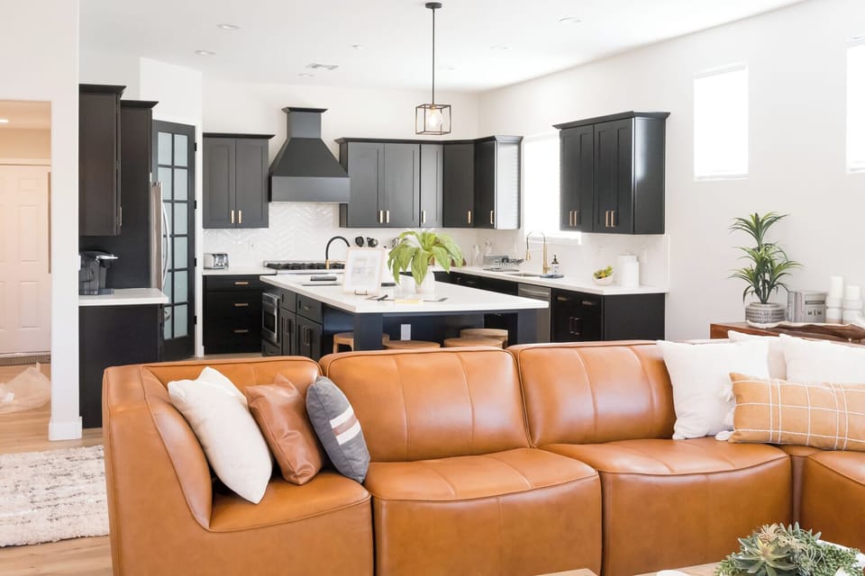 The well-furnished family room is steps from the open-concept kitchen