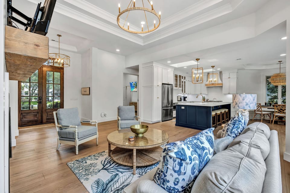 Step through the main entrance where a spacious, open-concept living area greets you, seamlessly connecting the kitchen and dining spaces.