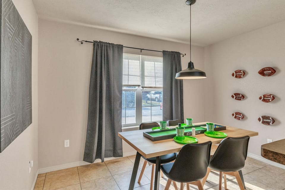 Gather around our game-day-inspired dining space! Perfect for enjoying meals, playing games, or planning your next adventure. Football fans will feel right at home!