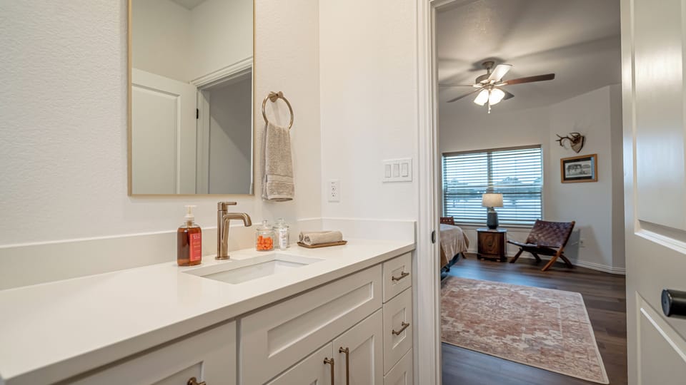 A clean, modern bathroom stocked with hotel-quality amenities. Fresh towels, quality fixtures, and everything you need to get ready for a game, concert, or a night out in the Near Southside.