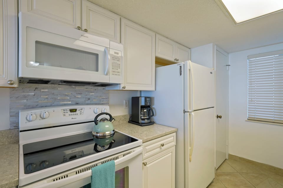 Fully stocked kitchen.  There is a coffee maker and a keurig in the kitchen. 