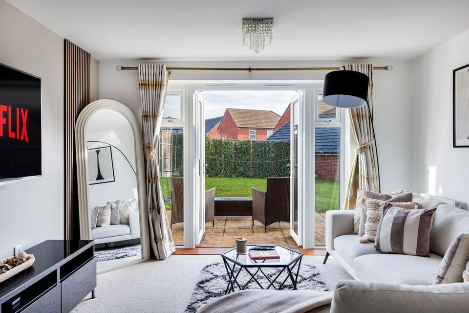 The living room features a large corner sofa and a 55'' Smart TV with Sky TV and Netflix subscriptions included