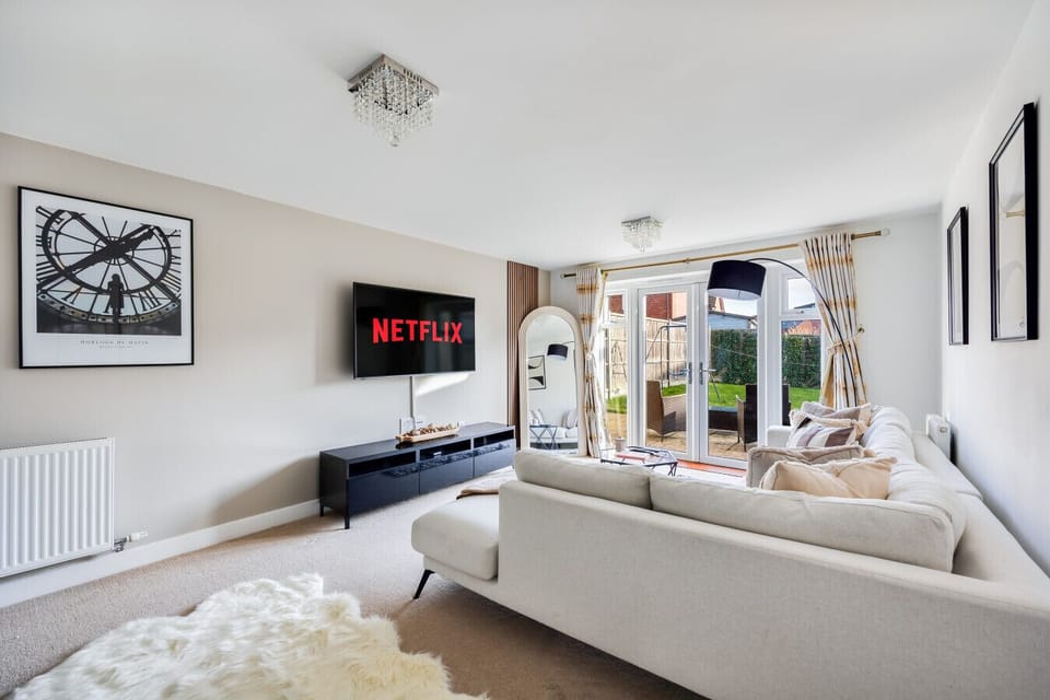 The living room features a large corner sofa and a 55'' Smart TV with Sky TV and Netflix subscriptions included