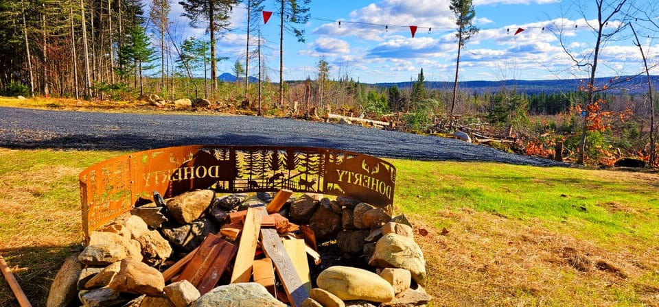 Custom outdoor fire pit with mountain views, string lights, and plenty of space to gather under the stars.