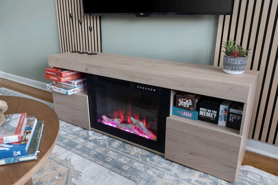 Board games and the electric fireplace, ready for a game night in. Streaming apps are on the Roku; just log in with your own accounts.