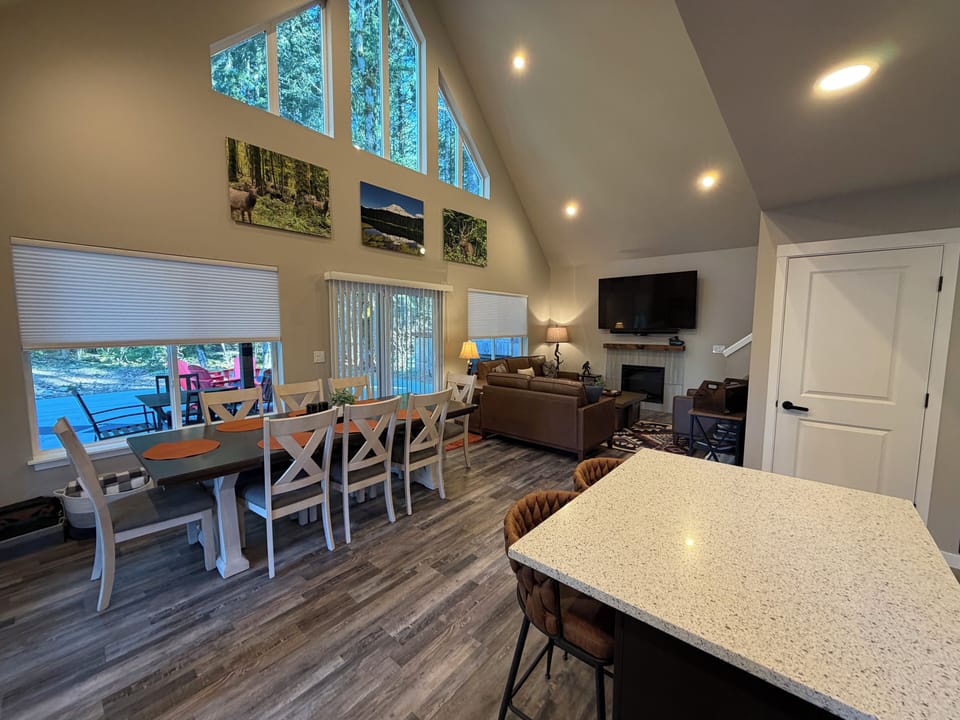 An open-concept view from the kitchen showcasing the dining area, kitchen island, and inviting living room—perfect for gathering, cooking, and staying connected.