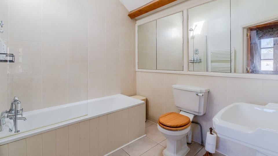 The en-suite has a bath and a shower