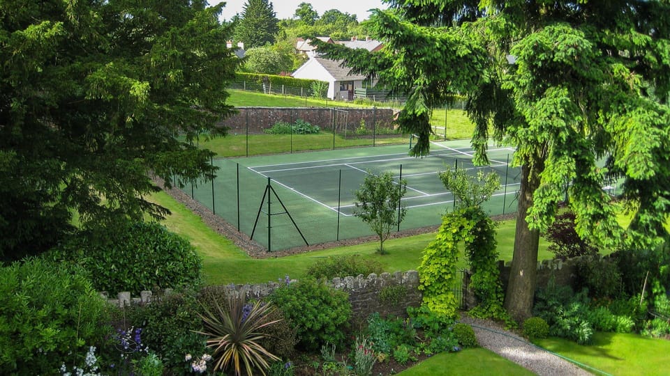 Host a mini-Wimbledon with your family at the shared tennis court