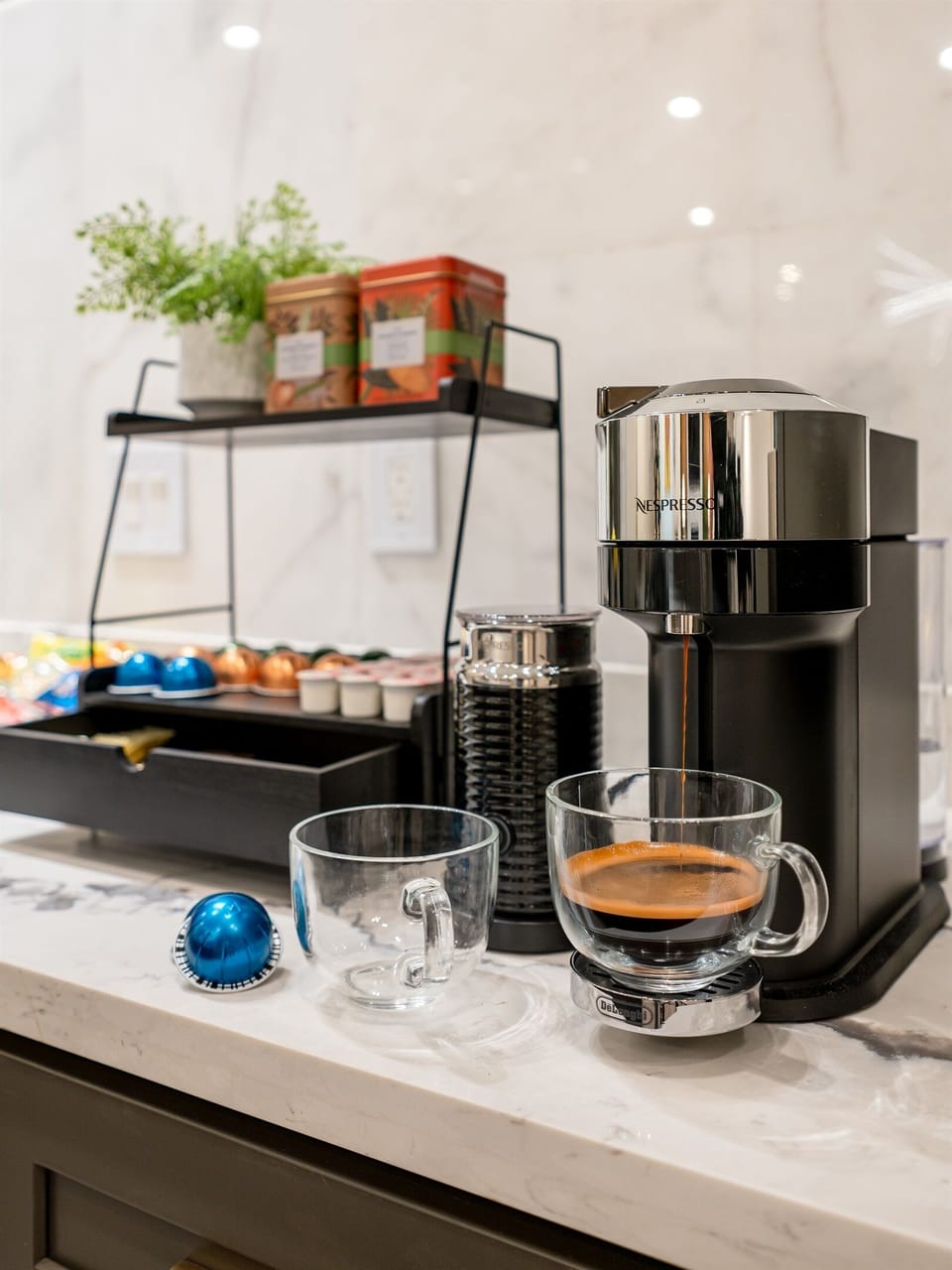 A coffee maker with a cup of coffee. 
