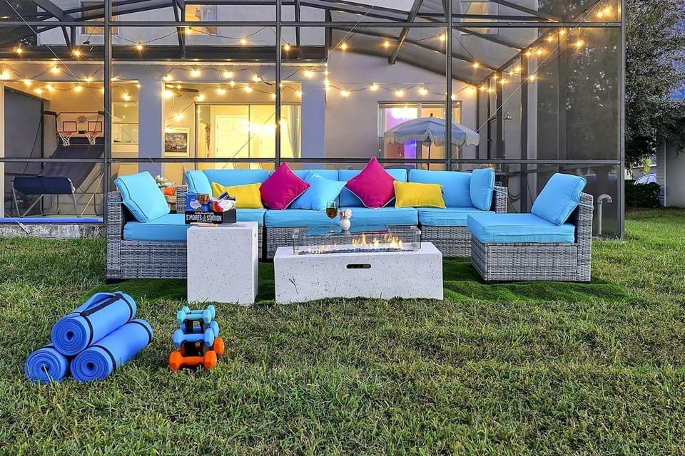 Vibrant outdoor seating and a s’mores-ready fire table set the scene for family nights, games, and laughter.