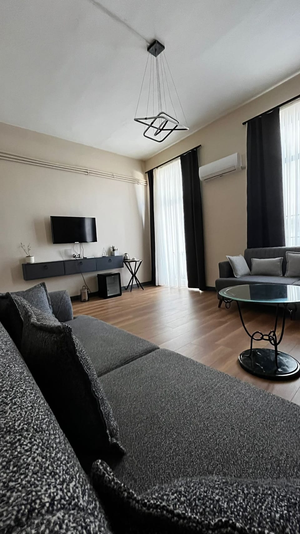 Family Quadruple Room | Living area | 82-inch LED TV with satellite channels