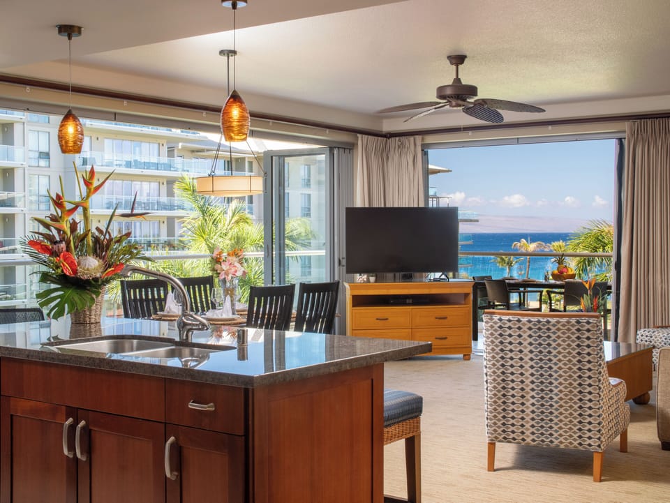 This airy living room offers floor-to-ceiling windows with an uninterrupted view of the ocean. Perfect for entertaining or unwinding after a day at the beach.