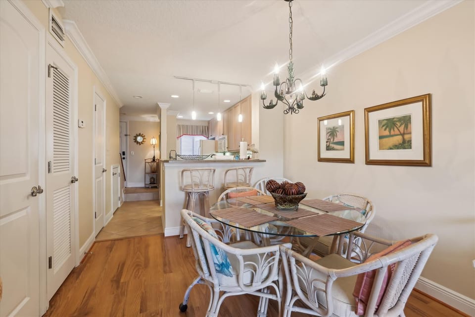 - Dining area with glass-top table and seating for six guests  
- Decorative chandelier lighting creates a warm and inviting space  
- Perfect for family dinners, game nights, or casual meals
