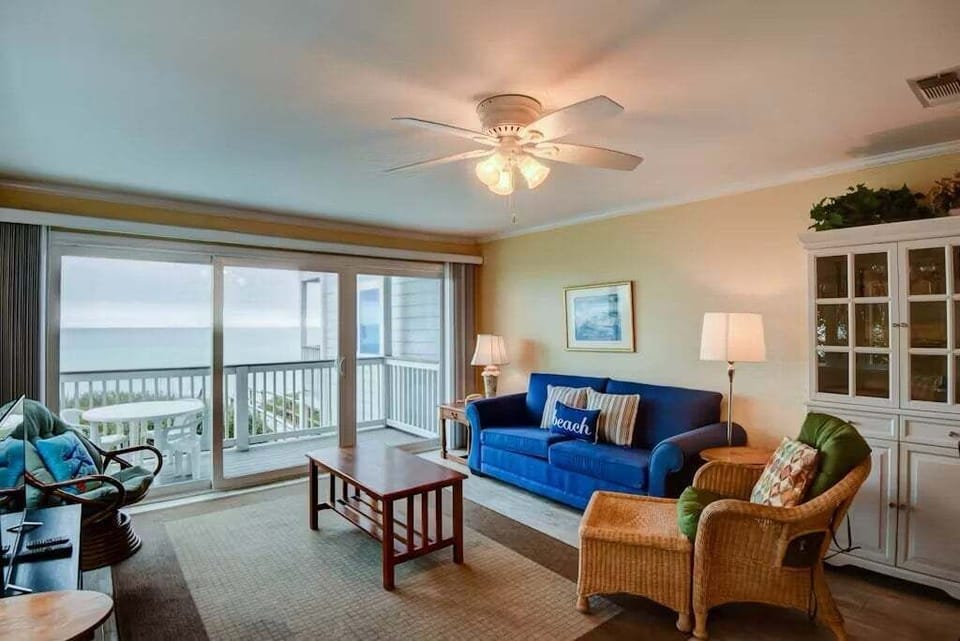 Open concept living area with stylish furnishings balcony access TV