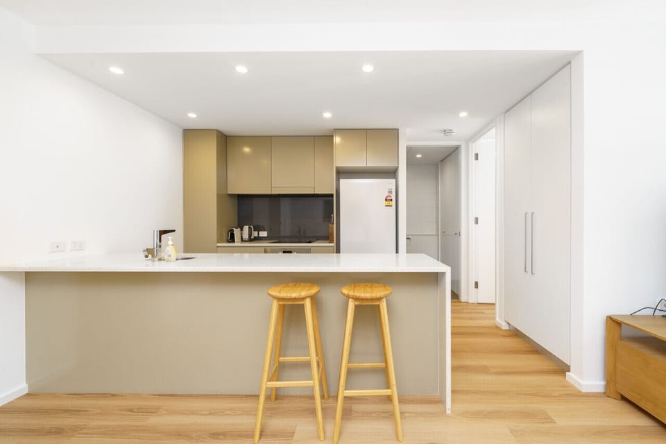 Two stylish stools are placed at the kitchen for added convenience.