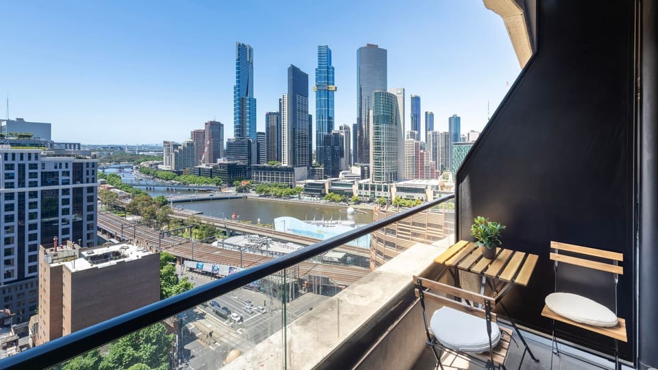 Private balcony with outdoor seating and panoramic Melbourne views