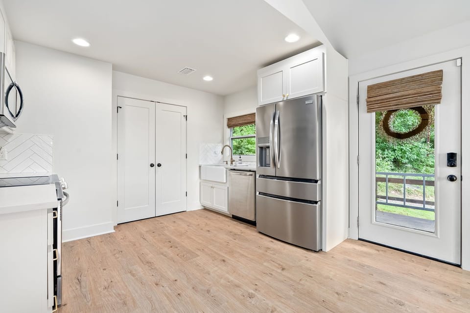 View of refrigerator, dishwasher and kitchen sink from master bedroom