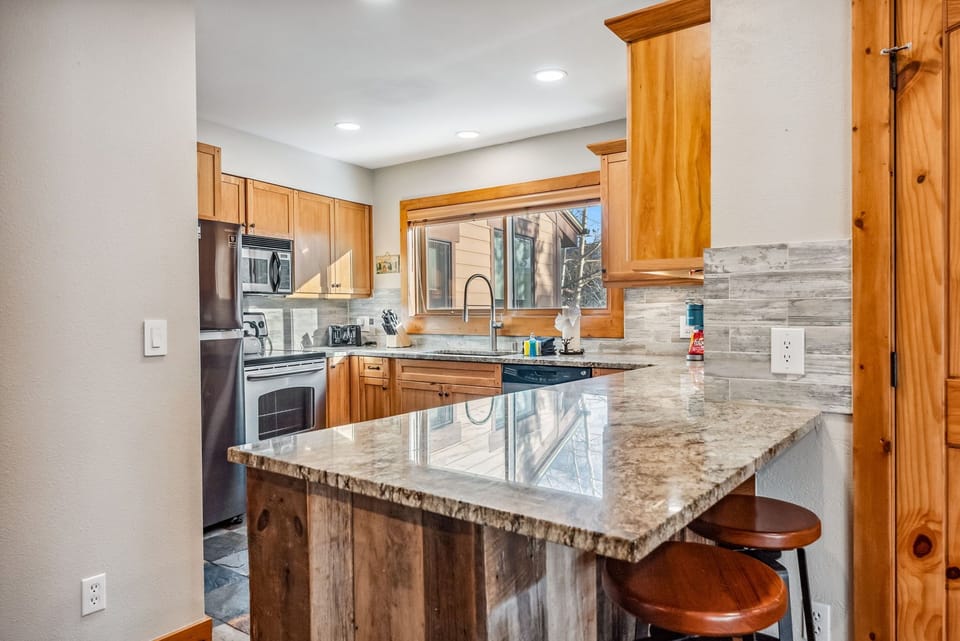 Kitchen with bar seating and mountain views.